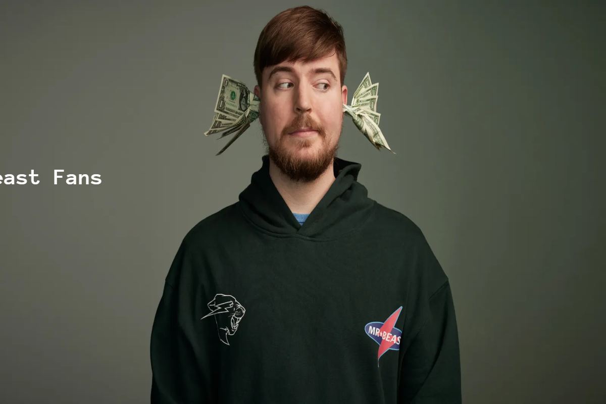 Man with dollar bills sticking out of his ears wearing a "MrBeast" hoodie.